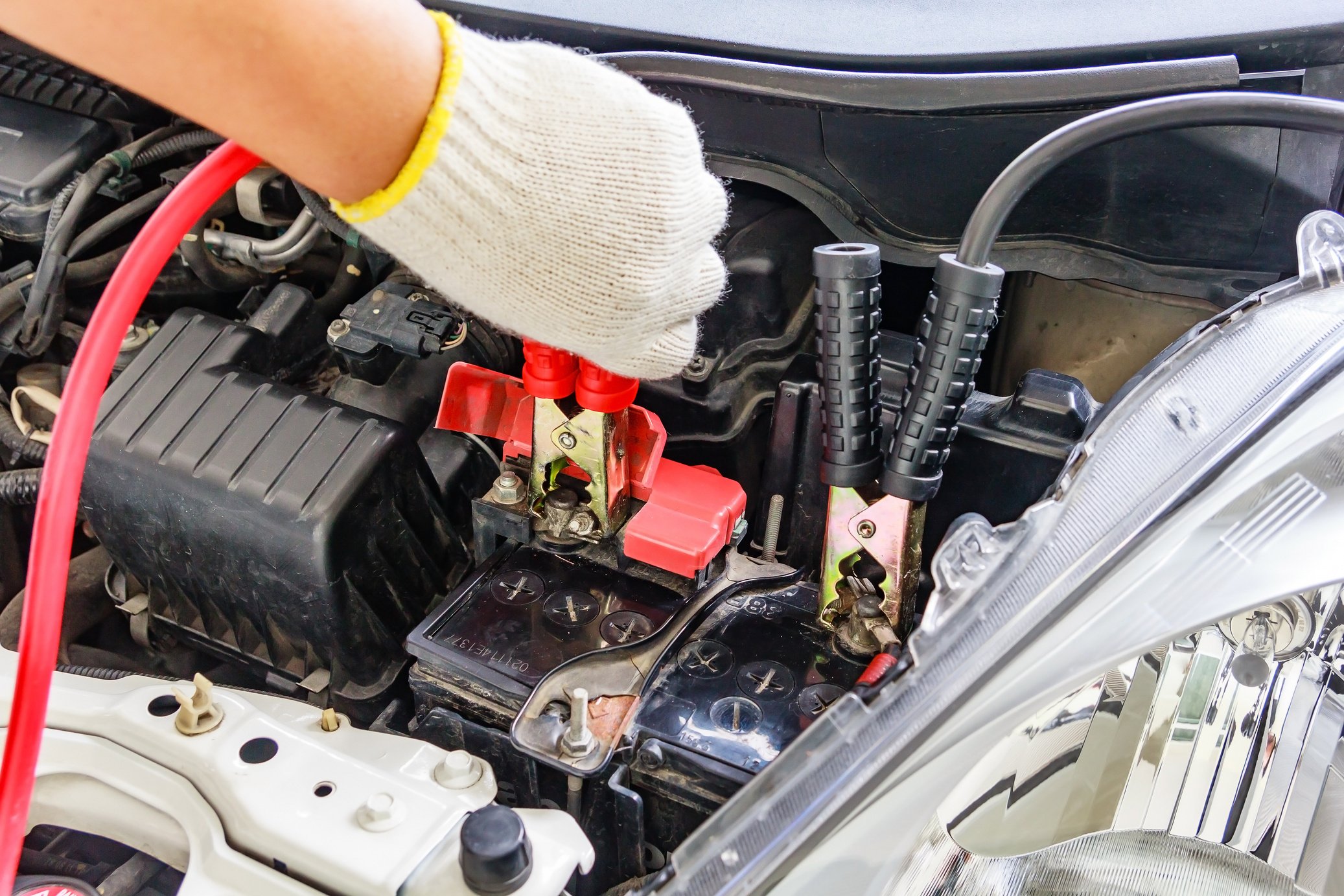 Mechanic Jump Starting a Car Battery